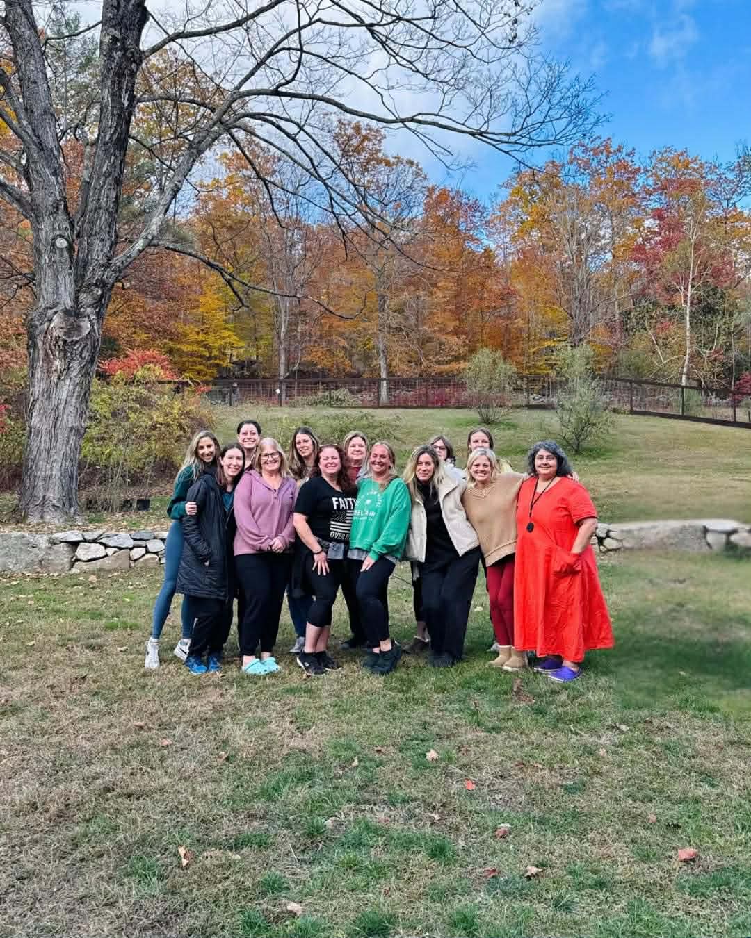 Group of women together outdoors in autumn, supporting one another